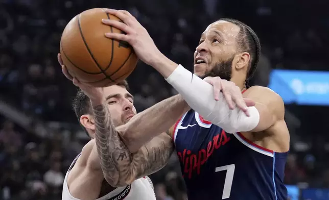 Los Angeles Clippers guard Amir Coffey, right, is fouled as he shoots by Memphis Grizzlies guard John Konchar during the first half of an NBA basketball game Wednesday, Feb. 12, 2025, in Inglewood, Calif. (AP Photo/Mark J. Terrill)