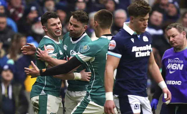 CORRECTS ID Ireland's Calvin Nash left, celebrates after scoring a try during the Six Nations match between Scotland and Ireland at Murrayfield Stadium, Edinburgh, Sunday Feb. 9, 2025. (Jane Barlow/PA via AP)