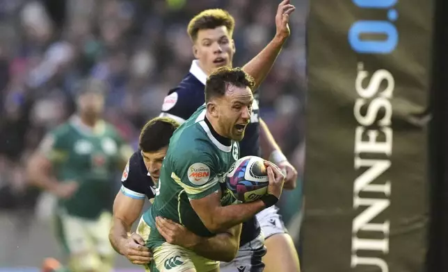 Ireland's Hugo Keenan is tackled by Scotland's Blair Kinghorn, left, during the Six Nations match between Scotland and Ireland at Murrayfield Stadium, Edinburgh, Sunday Feb. 9, 2025. (Andrew Milligan/PA via AP)
