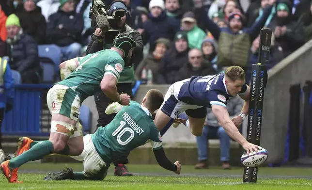 Scotland's Duhan van der Merwe scores a try during the Six Nations match between Scotland and Ireland at Murrayfield Stadium, Edinburgh, Sunday Feb. 9, 2025. (Andrew Milligan/PA via AP)