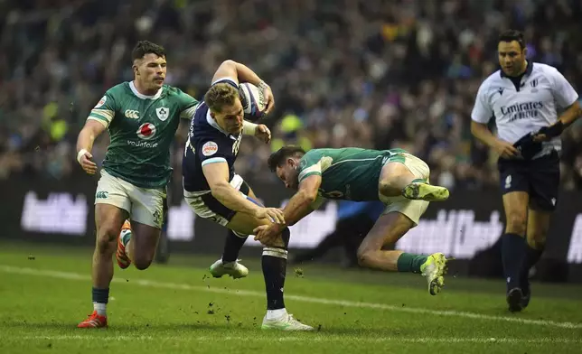 Scotland's Tom Jordan is tackled during the Six Nations match between Scotland and Ireland at Murrayfield Stadium, Edinburgh, Sunday Feb. 9, 2025. (Jane Barlow/PA via AP)