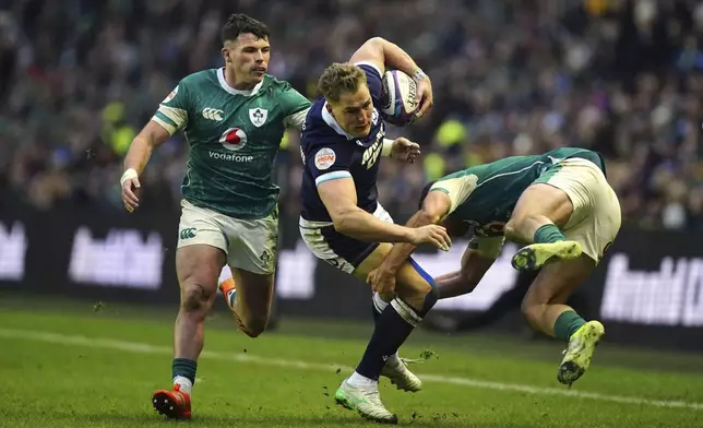 Scotland's Tom Jordan is tackled during the Six Nations match between Scotland and Ireland at Murrayfield Stadium, Edinburgh, Sunday Feb. 9, 2025. (Jane Barlow/PA via AP)