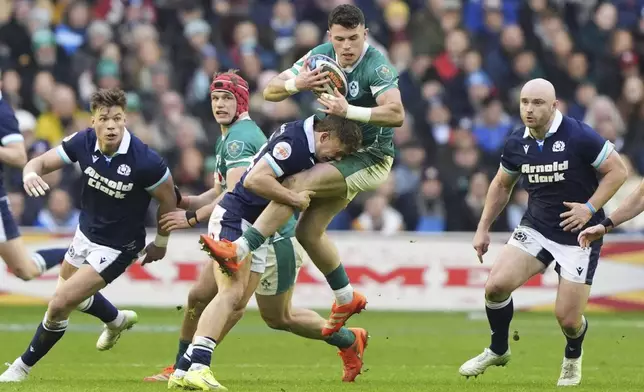Ireland's Calvin Nash is tackled by Scotland's Darcy Graham during the Six Nations match between Scotland and Ireland at Murrayfield Stadium, Edinburgh, Sunday Feb. 9, 2025. (Andrew Milligan/PA via AP)