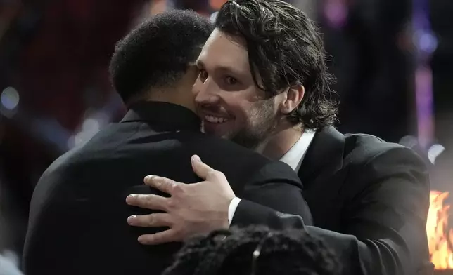 Buffalo Bills' Josh Allen, right, hugs Cleveland Browns' Myles Garrett during the NFL Honors award show ahead of the Super Bowl 59 football game, Thursday, Feb. 6, 2025, in New Orleans. (AP Photo/David J. Phillip)