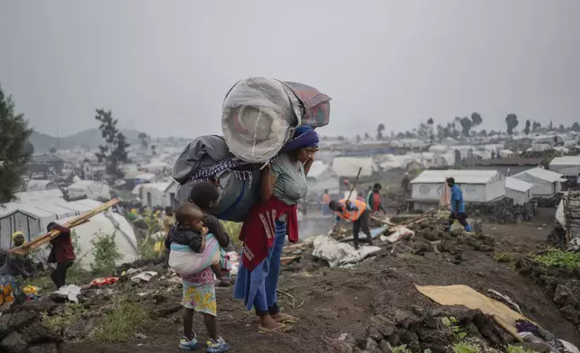People who were displaced by the fighting between M23 rebels and government soldiers leave their camp following an instruction by M23 rebels in Goma, Democratic Republic of the Congo, Tuesday, Feb. 11, 2025. (AP Photo/Moses Sawasawa)