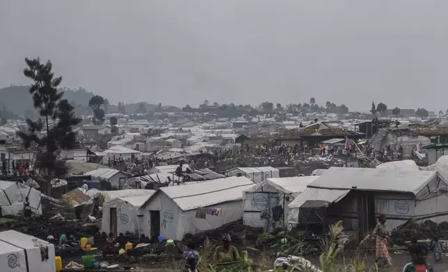 People who were displaced by the fighting between M23 rebels and government soldiers prepare to leave their camp following an instruction by M23 rebels in Goma, Democratic Republic of the Congo, Tuesday, Feb. 11, 2025. (AP Photo/Moses Sawasawa)