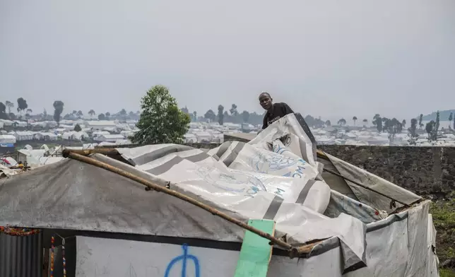 A man displaced by the fighting between M23 rebels and government soldiers prepares to leave the camp following an instruction by M23 rebels in Goma, Democratic Republic of the Congo, Tuesday, Feb. 11, 2025. (AP Photo/Moses Sawasawa)