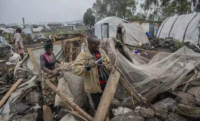 People who were displaced by the fighting between M23 rebels and government soldiers prepare to leave their camp following an instruction by M23 rebels in Goma, Democratic Republic of the Congo, Tuesday, Feb. 11, 2025. (AP Photo/Moses Sawasawa)