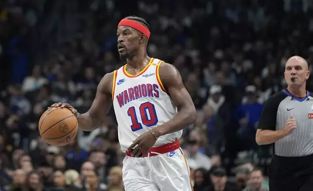 Golden State Warriors forward Jimmy Butler (10) dribbles during the first half of an NBA basketball game against the Dallas Mavericks in Dallas, Wednesday, Feb. 12, 2025. (AP Photo/LM Otero)