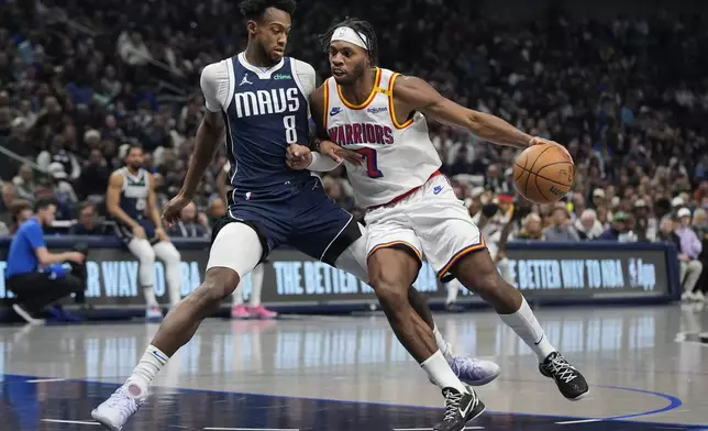 Golden State Warriors guard Buddy Hield (7) drives against Dallas Mavericks forward Olivier-Maxence Prosper (8) during the first half of an NBA basketball game in Dallas, Wednesday, Feb. 12, 2025. (AP Photo/LM Otero)