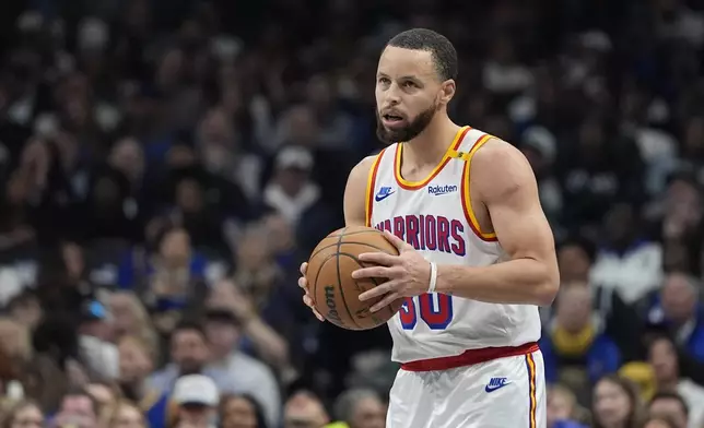 Golden State Warriors guard Stephen Curry (30) looks up while handling the ball during the first half of an NBA basketball game against the Dallas Mavericks in Dallas, Wednesday, Feb. 12, 2025. (AP Photo/LM Otero)