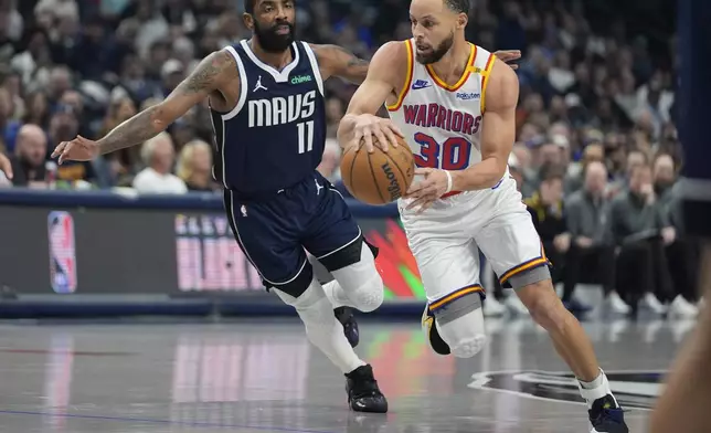 Golden State Warriors guard Stephen Curry (30) gets past Dallas Mavericks guard Kyrie Irving (11) during the first half of an NBA basketball game in Dallas, Wednesday, Feb. 12, 2025. (AP Photo/LM Otero)