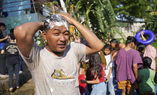 Samsul Anwar bathes by the Cisadane River, ahead the holy fasting month of Ramadan in Tangerang, Indonesia, Friday, Feb 28, 2025. (AP Photo/Tatan Syuflana)