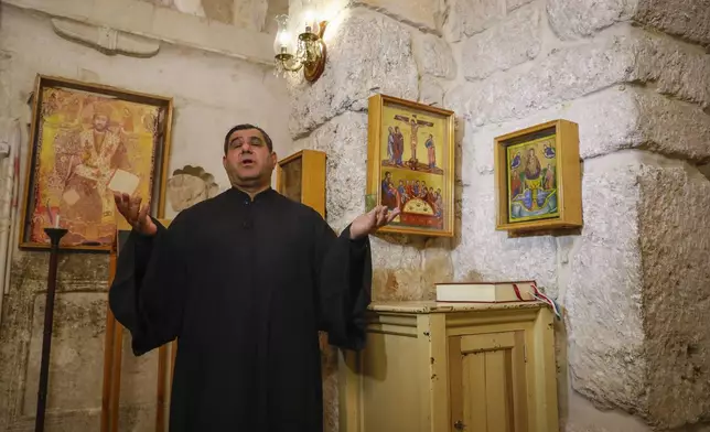 Father Fadi Bargeel prays at the Church of Saints Sergius and Bacchus in the town of Maaloula, Syria, Sunday, Jan. 12, 2025. (AP Photo/Omar Sanadiki)