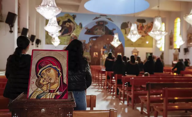 Syrian Christians gather for Sunday Mass at the Church of Saint George in the town of Maaloula, Syria, Sunday, Jan. 12, 2025. (AP Photo/Omar Sanadiki)