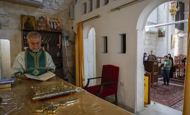 A priest holds Sunday Mass at the Greek Orthodox Convent of Saint Thecla in the town of Maaloula, Syria, Sunday Jan. 12, 2025. (AP Photo/Omar Sanadiki)