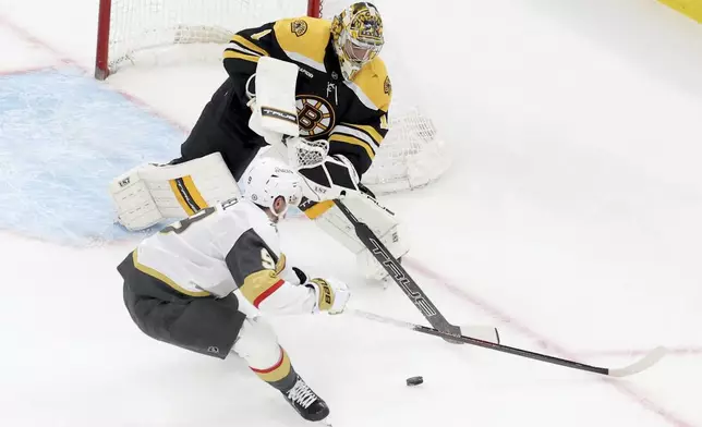 Boston Bruins goaltender Jeremy Swayman (1) defends the net against Vegas Golden Knights center Jack Eichel (9) during the second period of an NHL hockey game, Saturday, Feb. 8, 2025, in Boston. (AP Photo/Mark Stockwell)