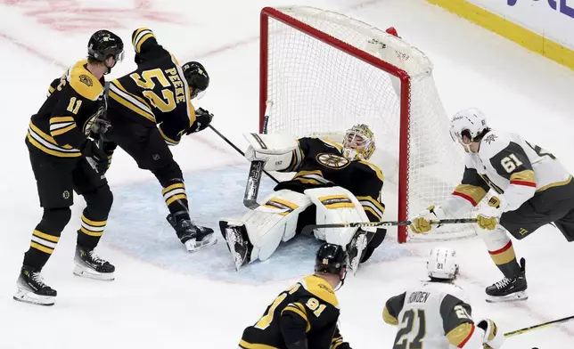 Vegas Golden Knights right wing Mark Stone (61) scores as Boston Bruins goaltender Jeremy Swayman (1) falls on top of the puck inside the net during the second period of an NHL hockey game, Saturday, Feb. 8, 2025, in Boston. (AP Photo/Mark Stockwell)