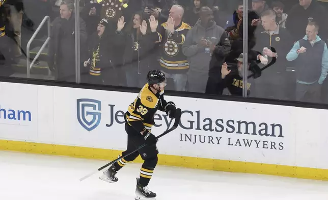 Boston Bruins center Morgan Geekie (39) skates past cheering fans after scoring during the second period of an NHL hockey game against the Vegas Golden Knights, Saturday, Feb. 8, 2025, in Boston. (AP Photo/Mark Stockwell)