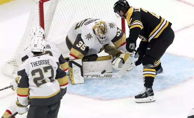 Vegas Golden Knights goaltender Ilya Samsonov (35) blocks a goal attempt by Boston Bruins center Elias Lindholm (28) during the second period of an NHL hockey game, Saturday, Feb. 8, 2025, in Boston. (AP Photo/Mark Stockwell)