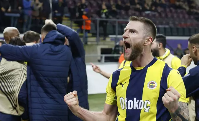 Fenerbahce's Milan Skriniar, celebrates after Fenerbahce's Yusuf Akcicek scored his sides second goal during the Europa League playoff second leg soccer match between Anderlecht and Fenerbahce at the RSC Anderlecht stadium in Brussels, Thursday, Feb. 20, 2025. (AP Photo/Omar Havana)