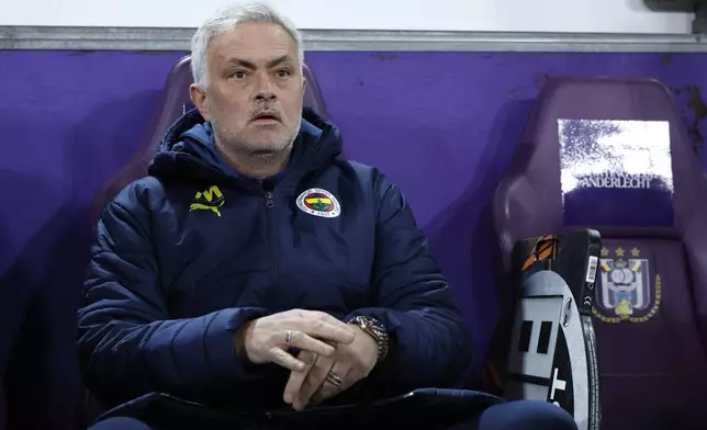 Fenerbahce's head coach Jose Mourinho, left, during the Europa League playoff second leg soccer match between Anderlecht and Fenerbahce at the RSC Anderlecht stadium in Brussels, Thursday, Feb. 20, 2025. (AP Photo/Omar Havana)
