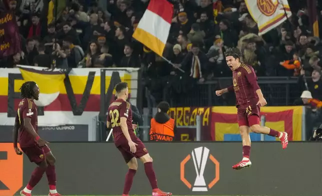 Roma's Paulo Dybala, right, celebrates with teammates after scoring his side's opening goal during the Europa League playoff second leg soccer match between Roma and Porto at the Stadio Olimpico in Rome, Italy, Thursday, Feb. 20, 2025. (AP Photo/Gregorio Borgia)
