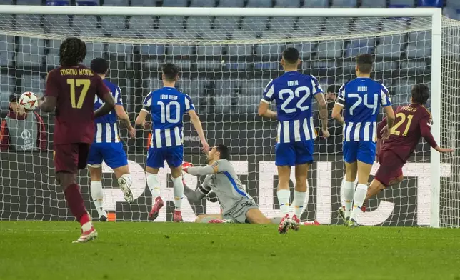 Roma's Paulo Dybala, right, scores his side's opening goal during the Europa League playoff second leg soccer match between Roma and Porto at the Stadio Olimpico in Rome, Italy, Thursday, Feb. 20, 2025. (AP Photo/Gregorio Borgia)