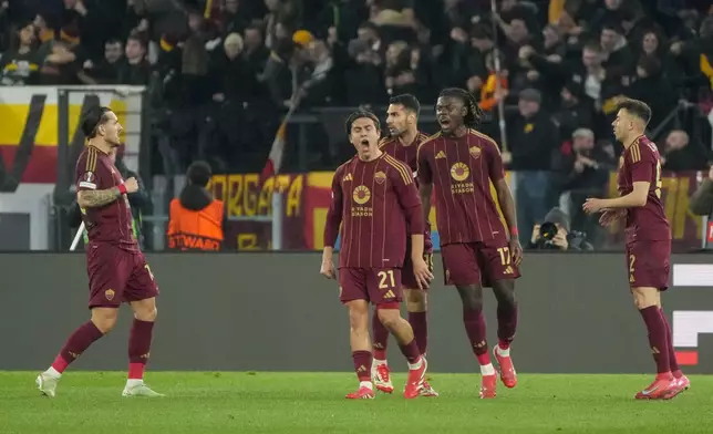 Roma's Paulo Dybala, center, celebrates with teammates after scoring his side's opening goal during the Europa League playoff second leg soccer match between Roma and Porto at the Stadio Olimpico in Rome, Italy, Thursday, Feb. 20, 2025. (AP Photo/Gregorio Borgia)