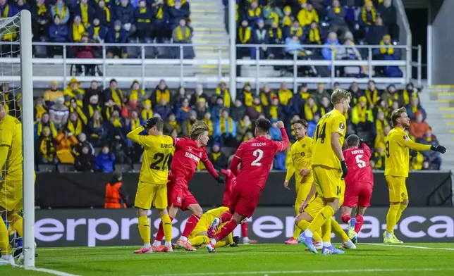 Twente's players celebrate after Bodø/Glimt's Fredrik Sjøvold scored an own goal during the Europa League soccer match between FK Bodø/Glimt and FC Twente in Bodo, Norway, Thursday, Feb. 20, 2025. (Fredrik Varfjell/NTB Scanpix via AP)