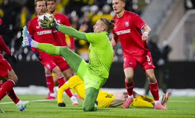 Twente's goalkeeper Lars Unnerstall makes a save during the Europa League soccer match between FK Bodø/Glimt and FC Twente in Bodo, Norway, Thursday, Feb. 20, 2025. (Fredrik Varfjell/NTB Scanpix via AP)