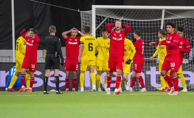 Twente's players react after missing a chance during the Europa League soccer match between FK Bodø/Glimt and FC Twente in Bodo, Norway, Thursday, Feb. 20, 2025. (Fredrik Varfjell/NTB Scanpix via AP)