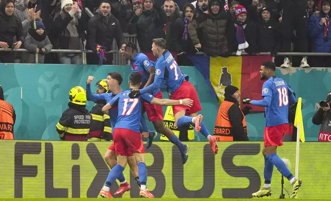 FCSB's David Miculescu, left, celebrates with team mates after scoring his side's second goalduring the Europa League playoff stage second leg soccer match between FCSB and PAOK at the National Arena stadium, Thursday, Feb. 20, 2025. (AP Photo/Andreea Alexandru)