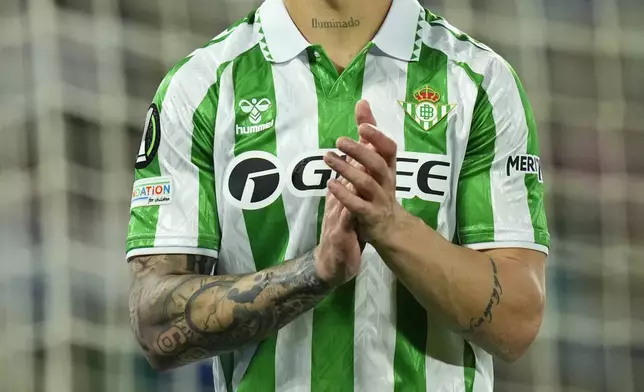 Betis' Antony applauds during the Conference League playoff second leg soccer match between Betis and Gent at the Benito Villamarin stadium in Seville, Spain, Thursday Feb. 20, 2025. (AP Photo/Jose Breton)