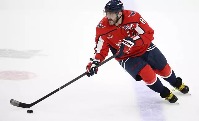 Washington Capitals left wing Alex Ovechkin (8) skates with the puck during overtime of an NHL hockey game against the Utah Hockey Club, Sunday, Feb. 9, 2025, in Washington. (AP Photo/Nick Wass)