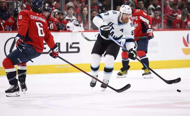 Utah Hockey Club left wing Lawson Crouse (67) passes the puck against Washington Capitals defenseman Jakob Chychrun (6) during the second period of an NHL hockey game, Sunday, Feb. 9, 2025, in Washington. (AP Photo/Nick Wass)