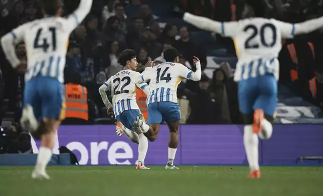 Brighton players celebrate after a goal during the English Premier League soccer match between Brighton and Chelsea in Brighton, England, Friday, Feb. 14, 2025. (AP Photo/Dave Shopland)