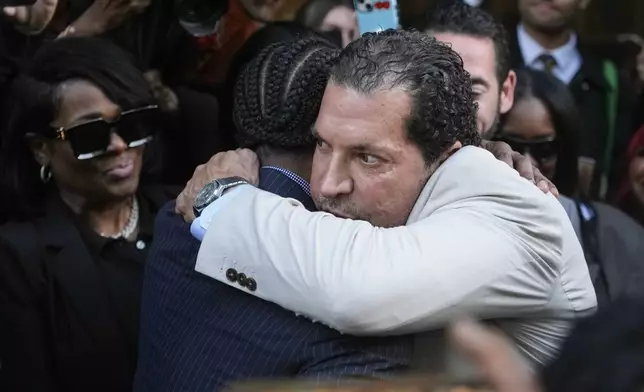 A$AP Rocky, center left, hugs attorney Joe Tacopina after he was found not guilty in his trial Tuesday, Feb. 18, 2025, in Los Angeles. (AP Photo/Damian Dovarganes)
