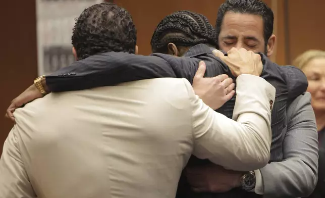 A$AP Rocky, center, is hugged in the courtroom after he was found not guilty during his trial Tuesday, Feb. 18, 2025, in Los Angeles. (Daniel Cole/Pool Photo via AP)
