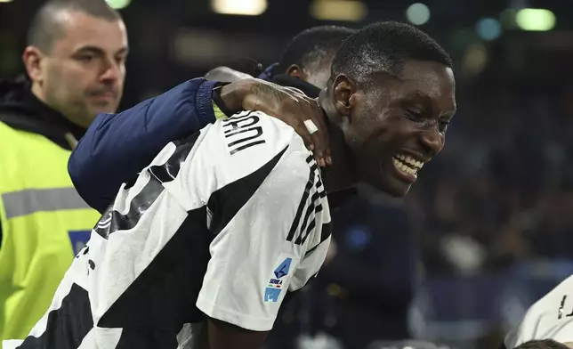 Juventus' Randal Kolo Muani, center, celebrates after scoring the team's first goal during the Serie A soccer match between Napoli and Juventus at the Diego Armando Maradona Stadium in Naples, Italy, Saturday Jan. 25, 2025. (Alessandro Garofalo/LaPresse via AP)