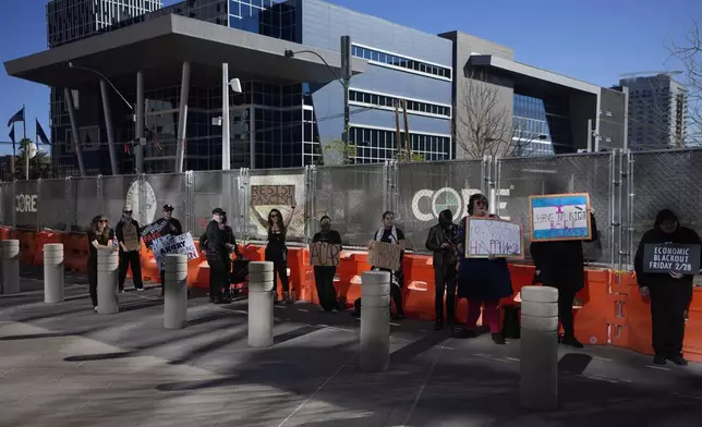 Protestors hold signs during a rally for a nationwide economic blackout Wednesday, Feb. 26, 2025, in Las Vegas. (AP Photo/John Locher)