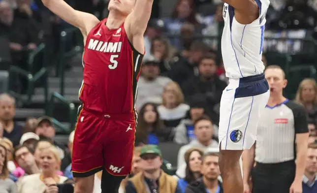 Dallas Mavericks guard Brandon Williams, right, shoots against Miami Heat forward Nikola Jovic during the first half of an NBA basketball game Thursday, Feb. 13, 2025, in Dallas. (AP Photo/Julio Cortez)