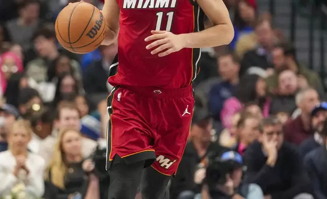 Miami Heat guard Jaime Jaquez Jr. dribbles up court against the Dallas Mavericks during the first half of an NBA basketball game Thursday, Feb. 13, 2025, in Dallas. (AP Photo/Julio Cortez)