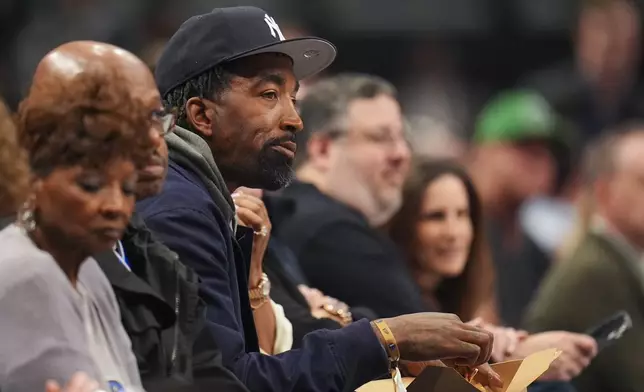Former NBA basketball player J. R. Smith watches during the first half a game between the Dallas Mavericks and the Miami Heat Thursday, Feb. 13, 2025, in Dallas. (AP Photo/Julio Cortez)
