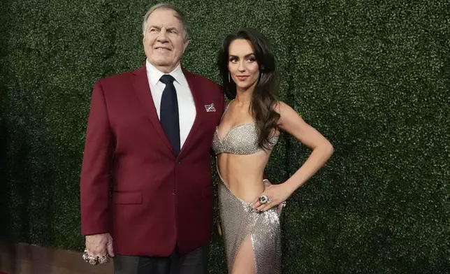 Former NFL head coach Bill Belichick and girlfriend Jordon Hudson, pose on the red carpet at the NFL Honors award show ahead of the Super Bowl 59 football game, Thursday, Feb. 6, 2025, in New Orleans. (AP Photo/Brynn Anderson)