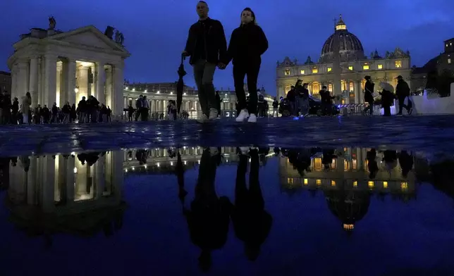 People walk outside St. Peter's Square at The Vatican, Monday, Feb. 24, 2025. (AP Photo/Kirsty Wigglesworth)