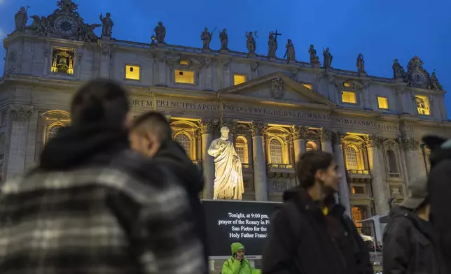 People wait in St. Peter's Square at The Vatican for the start of a rosary vigil prayer for Pope Francis' recovery, Monday, Feb. 24, 2025. (AP Photo/Mosa'ab Elshamy)