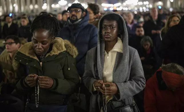 Faithful gather to pray the rosary for the health of Pope Francis in St. Peter's Square at The Vatican, Monday, Feb. 24, 2025. (AP Photo/Bernat Armangue)