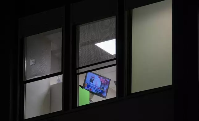 A television shows news about Pope Francis in a room of the Agostino Gemelli Polyclinic, in Rome, Sunday, Feb. 23, 2025, where the pontiff is hospitalized in stable but critical condition since Friday, Feb. 14. (AP Photo/Andrew Medichini)