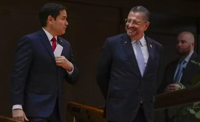 Secretary of State Marco Rubio, left, and Costa Rican President Rodrigo Chaves arrive to give a joint news conference at the presidential palace in San Jose, Costa Rica, Tuesday, Feb. 4, 2025. (AP Photo/Mark Schiefelbein, Pool)